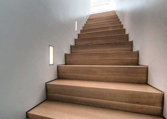lighted wood stairs white walls